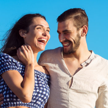 laughing couple against the blue sky