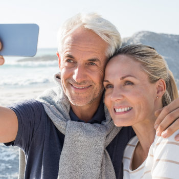 mature couple smiling and taking a selfie