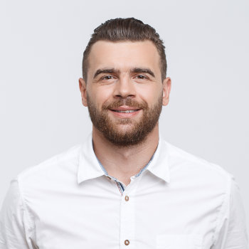 young man with beard is smiling