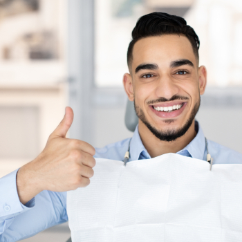 Smiling Man Enjoying Successful Teeth Treatment In Modern Clinic